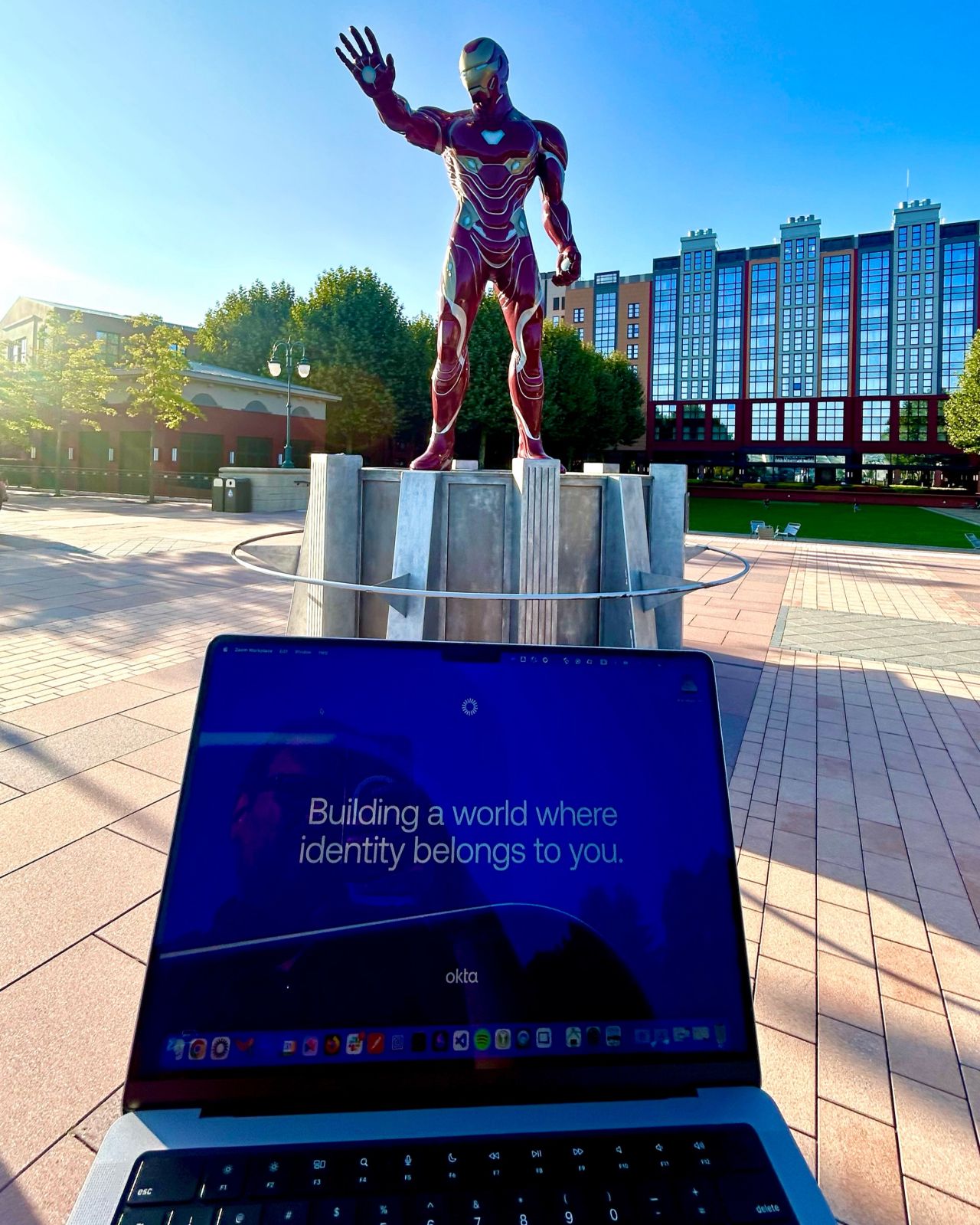 Okta laptop with Iron Man in the background