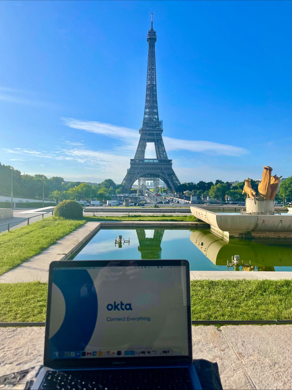 Laptop showing Okta in front of the Eiffel Tower in Paris