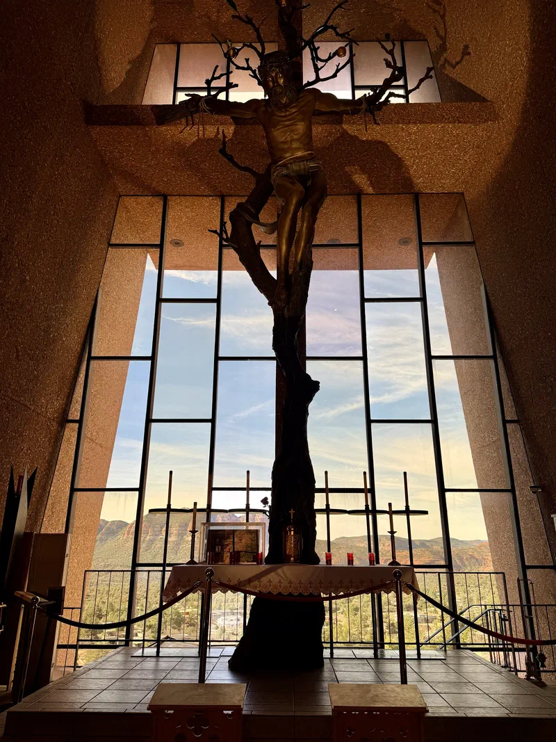 Interior of the Chapel of the Holy Cross with sculptural cross and panoramic view